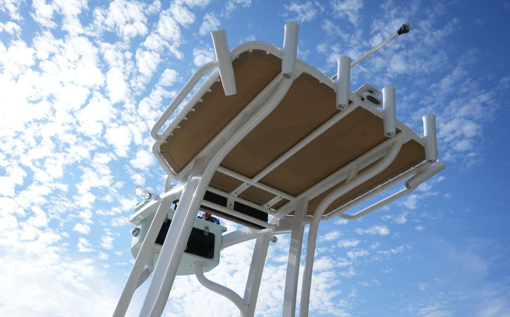 The top of the half tower second station on a Blazer Bay 2440. The image focuses on the stretched tarp of the second station that casts shade onto the main seating area of the boat.