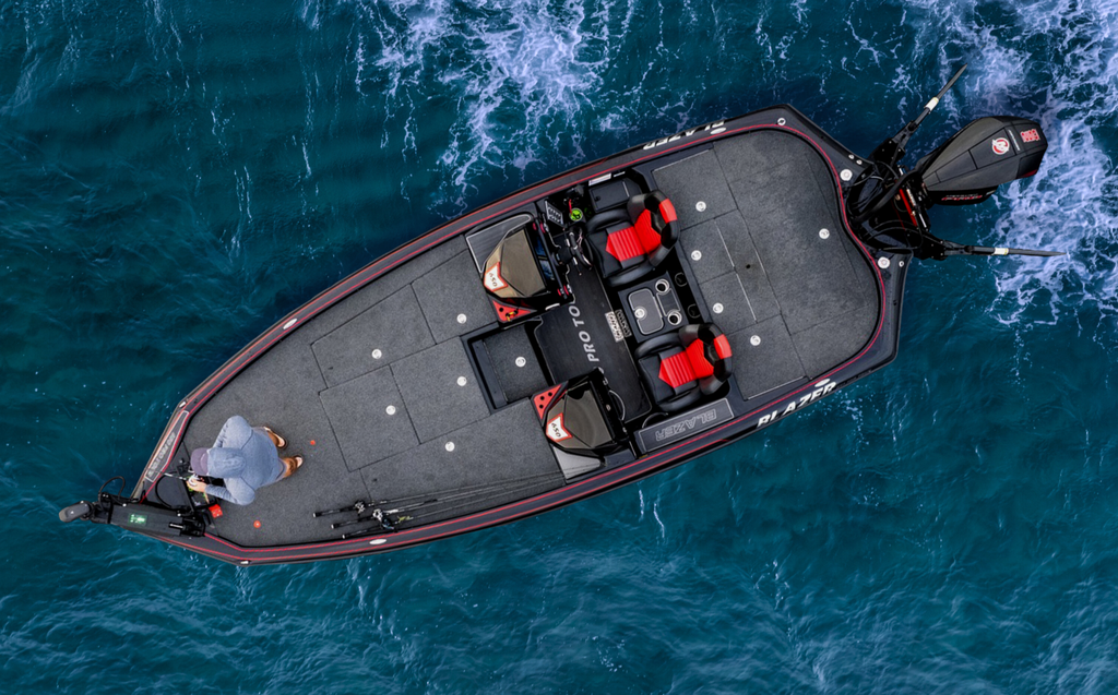 A top-down view of the 650 Pro Tour on top of a body of water. Near the nose of the boat, an angler is standing with a fishing rod.
